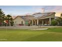 Home with solar panels and a fenced yard backing onto a golf course with lush green grass at 14123 W Greentree S Dr, Litchfield Park, AZ 85340