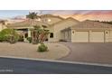 Single-story desert home with porte-cochere, three-car garage, and desert landscaping at 14123 W Greentree S Dr, Litchfield Park, AZ 85340