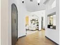Bright foyer features light wood floors, white walls, and an arched entryway to the living room at 14123 W Greentree S Dr, Litchfield Park, AZ 85340