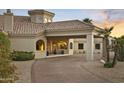 Beautiful desert home with porte-cochere, desert landscaping, brick driveway, and orange sky sunset at 14123 W Greentree S Dr, Litchfield Park, AZ 85340