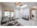 Bright living room with ceiling fan, neutral decor and large window at 14300 W Bell Rd # 100, Surprise, AZ 85374