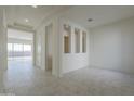 Spacious living room with neutral tile flooring and ample natural light at 16367 W Desert Mirage Dr, Surprise, AZ 85388