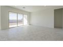 Open living area with large sliding glass doors providing access to the backyard at 16367 W Desert Mirage Dr, Surprise, AZ 85388