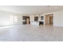 Spacious open-concept layout with a kitchen island and stainless steel appliances at 18950 W Ocotillo Rd, Waddell, AZ 85355