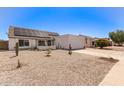 Exterior shot of home with solar panels, a two-car garage, and low-maintenance desert landscaping at 19413 N 8Th St, Phoenix, AZ 85024