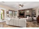 Bright living room with a stone fireplace, large sectional sofa and neutral color palette at 20139 E Via Del Oro --, Queen Creek, AZ 85142