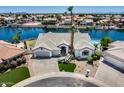 Attractive home featuring well-maintained landscaping, a circular driveway, and a three-car garage at 21663 N 57Th Ave, Glendale, AZ 85308