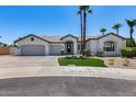 Charming home featuring a three-car garage, beautiful landscaping, and a well-maintained front yard at 21663 N 57Th Ave, Glendale, AZ 85308