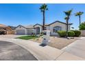 Home with a three-car garage, desert landscaping, and a decorative mailbox at 21663 N 57Th Ave, Glendale, AZ 85308