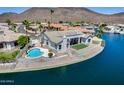 Waterfront home with pool, covered patio, and mountain views, perfect for outdoor enjoyment at 21663 N 57Th Ave, Glendale, AZ 85308