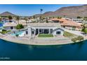 Waterfront home with pool, covered patio, and artificial grass, perfect for outdoor living at 21663 N 57Th Ave, Glendale, AZ 85308