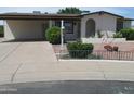 Charming single-story home with well-maintained landscaping and a cozy, inviting entrance at 2324 W Via Rialto Cir, Mesa, AZ 85202