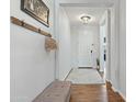 Bright entryway features wood flooring, a cozy bench, and coat rack at 23637 W Hopi St, Buckeye, AZ 85326
