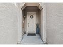 Welcoming front door featuring an arched entry, wreath, and elegant potted plant at 23637 W Hopi St, Buckeye, AZ 85326