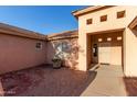Home entrance featuring a charming brick courtyard and covered front porch at 23717 N Mustang Way, Florence, AZ 85132
