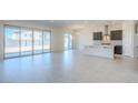 Open-concept living and kitchen area with sliding glass doors and tile flooring at 242 S 165Th Ave, Goodyear, AZ 85338