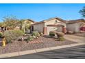 Charming home with a desert landscape, mature plants, and a two-car garage at 2462 W Turtle Hill Dr, Anthem, AZ 85086