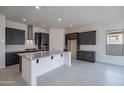 Modern kitchen featuring stainless steel appliances, a large center island, and stylish cabinetry at 257 S 165Th Ave, Goodyear, AZ 85338