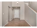 Bright foyer with neutral walls, tile flooring, a coat closet and a view of the staircase at 2718 S Cupertino Dr, Gilbert, AZ 85295