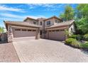 Charming two-story home with a three-car garage and beautiful desert landscaping in the front yard at 2856 E Desert Broom Pl, Chandler, AZ 85286