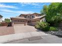 Beautiful two-story home with a three-car garage and a well-maintained desert landscape at 2856 E Desert Broom Pl, Chandler, AZ 85286