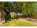 A lawn area with several mature shade trees provides backyard enjoyment at 325 E Sharon Ave, Phoenix, AZ 85022