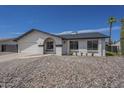 Charming home featuring desert landscaping, an arched entryway, and a white exterior paint scheme at 3722 W Michelle Dr, Glendale, AZ 85308