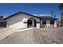 Single-story home showcasing a well-maintained front yard with desert landscaping and a two-car garage at 3722 W Michelle Dr, Glendale, AZ 85308