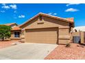 Attractive house showcasing a two-car garage and vibrant desert landscaping at 3971 N 151St Ln, Goodyear, AZ 85395