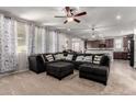 Comfortable living room featuring plush seating, abundant natural light, and seamlessly connects to the modern kitchen at 4068 E Devon Dr, Gilbert, AZ 85296