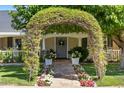 Inviting entrance with a beautiful floral archway and stone pathway at 4111 N 52Nd St, Phoenix, AZ 85018