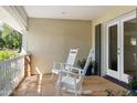 Cozy front porch with two rocking chairs and a view of the well-manicured lawn at 4111 N 52Nd St, Phoenix, AZ 85018