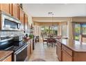 Well-lit kitchen with stainless steel appliances, tile flooring, and a dining area overlooking the backyard at 5090 E Sleepy Ranch Rd, Cave Creek, AZ 85331