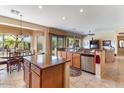 Spacious kitchen with a breakfast bar, stainless steel appliances, granite countertops, and tile flooring at 5090 E Sleepy Ranch Rd, Cave Creek, AZ 85331