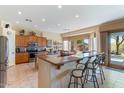 Bright, open kitchen featuring a breakfast bar, tile floors, stainless steel appliances, and a scenic backyard view at 5090 E Sleepy Ranch Rd, Cave Creek, AZ 85331