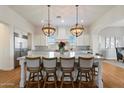 Beautiful kitchen island has pendant lights and seating, perfect for entertaining and casual dining at 6535 W Gold Mountain Pass, Phoenix, AZ 85083