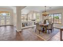 Open-concept dining room is adjacent to the living room, featuring decorative chandelier and backyard views at 7524 E Leland Cir, Mesa, AZ 85207