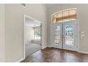 Spacious entryway boasts high ceilings, tile flooring, and double doors leading into the home and den/office at 7524 E Leland Cir, Mesa, AZ 85207