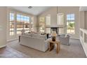 Bright and spacious living room featuring vaulted ceilings, fireplace, large windows and neutral tones at 7524 E Leland Cir, Mesa, AZ 85207