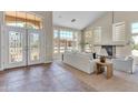 Bright living room featuring soaring ceilings, large windows, tile entry, fireplace, and comfortable seating at 7524 E Leland Cir, Mesa, AZ 85207