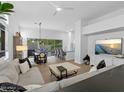 Open-concept living area with tile floors, modern furnishings, and sliding glass doors to the backyard at 7673 E Sands Dr, Scottsdale, AZ 85255