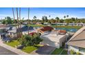 Beautiful waterfront house with a private driveway and lush green landscaping at 8210 E Del Cadena Dr, Scottsdale, AZ 85258