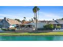 Waterfront home with a fenced backyard, swimming pool and outdoor living area at 8210 E Del Cadena Dr, Scottsdale, AZ 85258