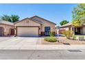 Inviting single-story home with well-maintained landscaping, attached garage, and a cozy bench near the entrance at 8921 W Laurel Ln, Peoria, AZ 85345