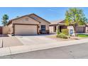 Attractive home with an attached garage and easy-care landscape showcasing inviting curb appeal at 8921 W Laurel Ln, Peoria, AZ 85345