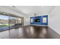 Open living space with a sliding glass door leading to the backyard and a statement wall at 9936 E Revolution Dr, Mesa, AZ 85212
