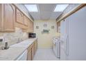 Well-maintained kitchen with white appliances and ample counter space at 10020 W Royal Oak Rd # F, Sun City, AZ 85351