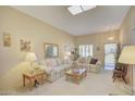Cozy living room featuring neutral paint, carpet and comfortable seating arrangement at 10020 W Royal Oak Rd # F, Sun City, AZ 85351