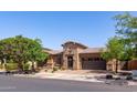 Charming single-Gathering home with desert landscaping, an inviting entrance, and a two-car garage at 10402 E Starion Ave, Mesa, AZ 85212