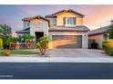 Stunning two-story home featuring a three-car garage, desert landscaping, and a welcoming entrance with palm trees at 11127 E Tripoli Ave, Mesa, AZ 85212